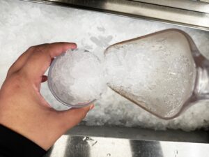 top view of person scooping flake ice into cup